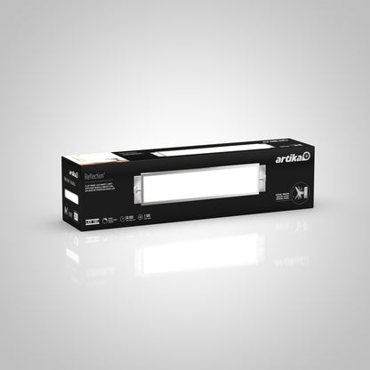 A rectangular black box labeled Artika contains a Reflection Flat Panel LED bathroom vanity light, with the fixture image and product details on the packaging, set against a plain gray background.