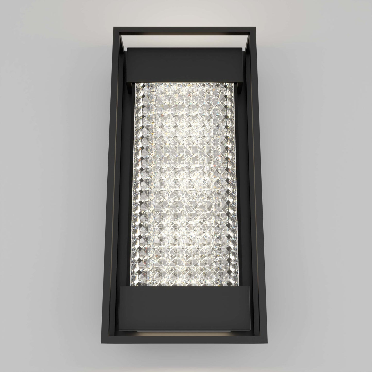 The Artika Glam indoor-outdoor LED wall light features a modern rectangular design with a black frame and sparkling crystal-like panel, casting bright, diffused light against a plain light gray wall.