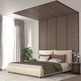 A modern bedroom with a beige bed, green blanket, mauve pillows, vertical slatted wood paneling extending onto the ceiling, a potted plant, floor-length curtains, and a small side table with vases.