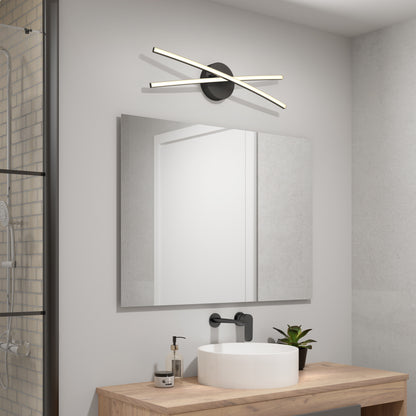 A modern bathroom featuring the Artika Orly modern LED bathroom vanity light 3 CCT above a rectangular mirror, with a wooden sink vanity, round white basin, black faucet, and a small potted plant.