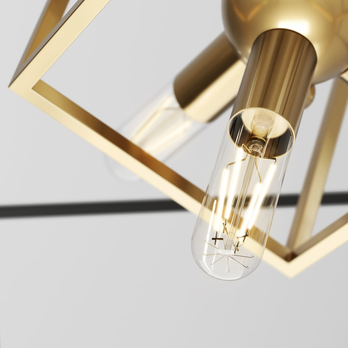 Close-up of a modern light fixture with a gold metallic frame and exposed light bulb, featuring clean lines and a minimalistic design against a neutral background.