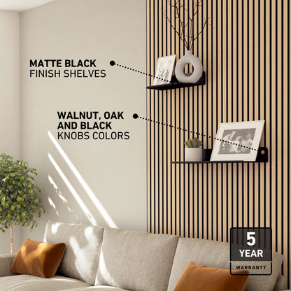 Living room with Artika Sonokit shelves & hooks on Sonolok/Sonofold panels, framed photo, plant & 5-year warranty badge.