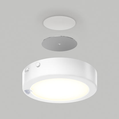 The Artika Accent under cabinet LED light 3CCT is shown disassembled with its mounting plate and a small circular cover above, all set against a plain gray background.