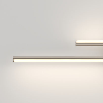 Minimalist image of two Artika Cisco modern LED bathroom vanity lights (5 CCT) on a plain, light wall: the longer fixture is bottom left, the shorter top right. Both emit a soft, warm glow.