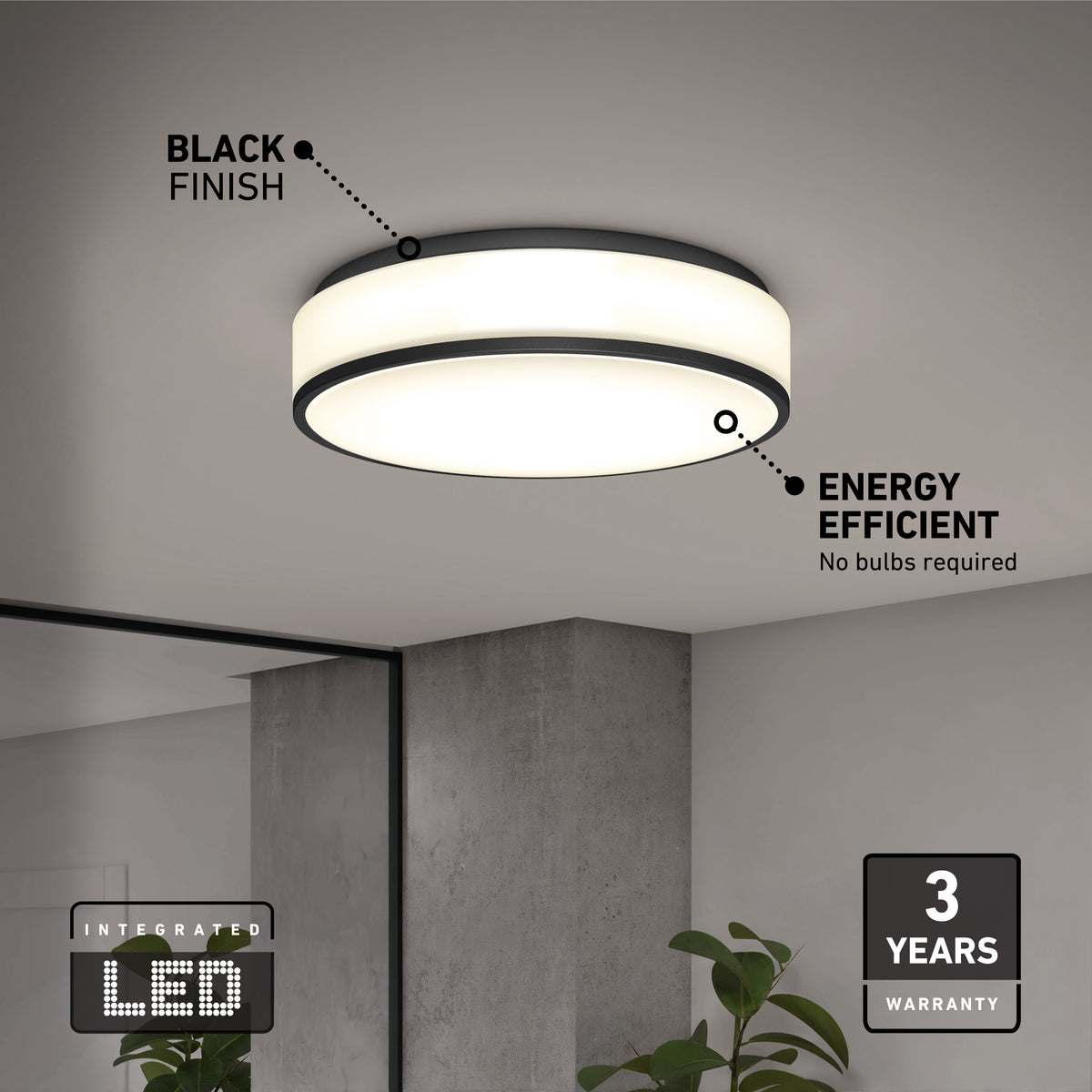 The Artika Giada 15 in. LED modern flush mount light (5 CCT), shown with a black finish in a minimal room, features integrated energy-efficient LEDs and a 3-year warranty. A plant and mirror are partially visible below the fixture.