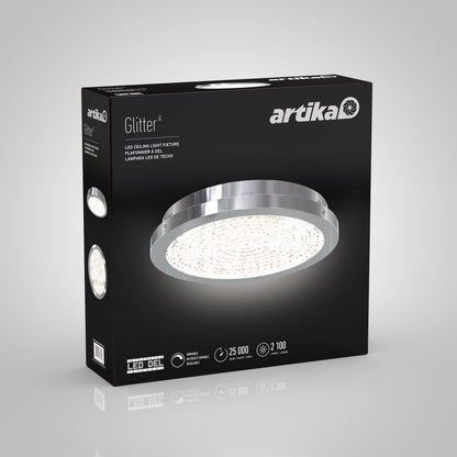 Black Artika box featuring the Glitter LED flush mount, shown with a round design and chrome finish. The front displays product details and icons for lifespan, brightness, and energy efficiency.