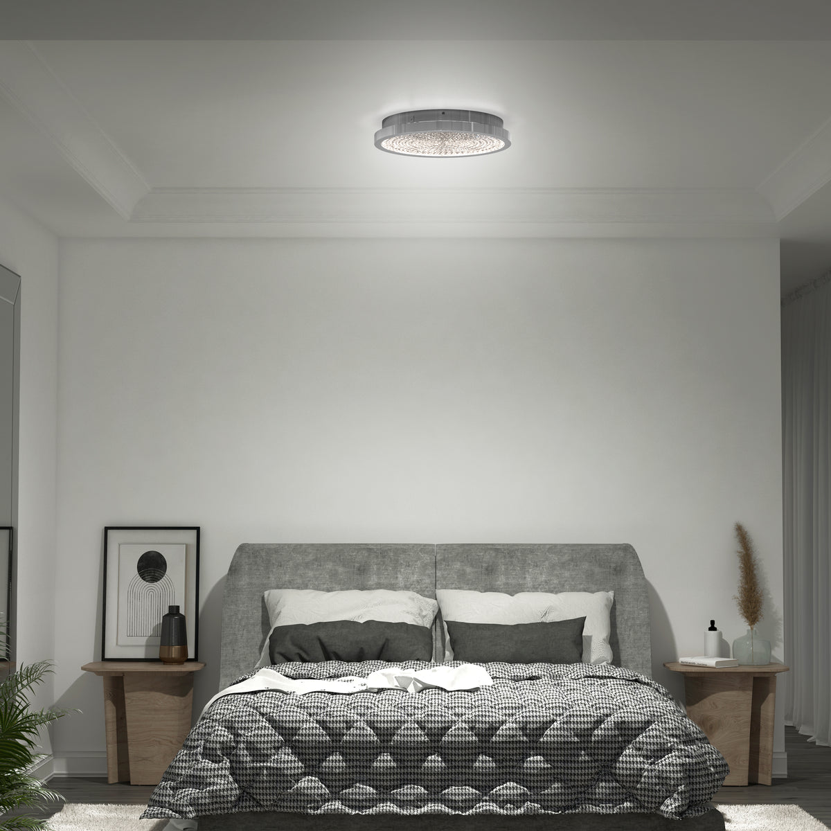 A modern bedroom with a gray upholstered bed, checkered bedding, two wooden nightstands with decor, and a round ceiling light. Minimalist artwork and plants add simple, cozy touches to the space.