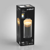 A black product box for the Artika Hanson pendant light, featuring an image of the light fixture with a wood accent and cylindrical glass shade, plus product details and icons on the packaging.