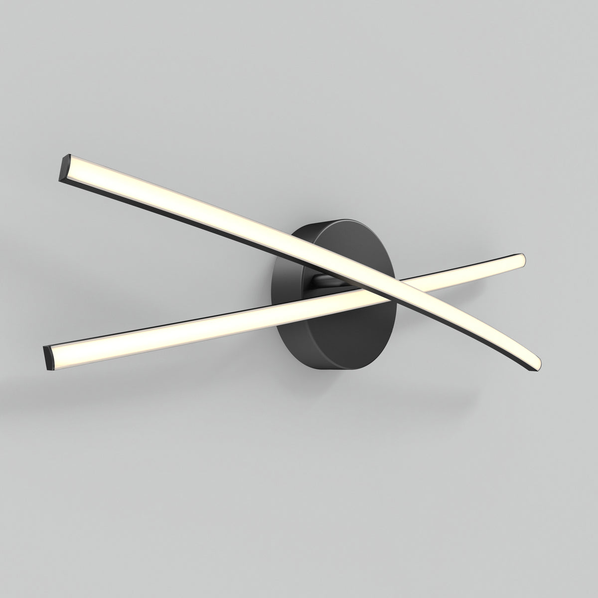 A modern wall light fixture with two curved, illuminated bars crossing over each other, attached to a round black base, mounted on a plain light grey wall.