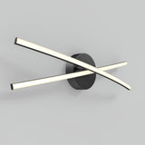 A modern wall light fixture with two curved, illuminated bars crossing over each other, attached to a round black base, mounted on a plain light grey wall.