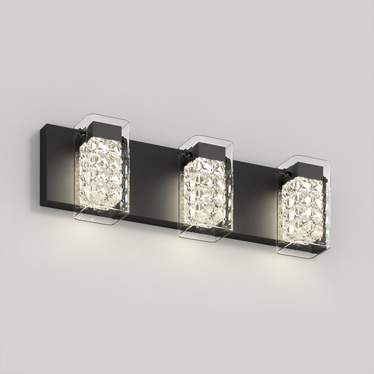 The Artika Crystal Cube LED bathroom vanity light 5 CCT features a black rectangular base and three crystal-like square glass shades, each housing a glowing bulb, elegantly mounted on a light gray wall.