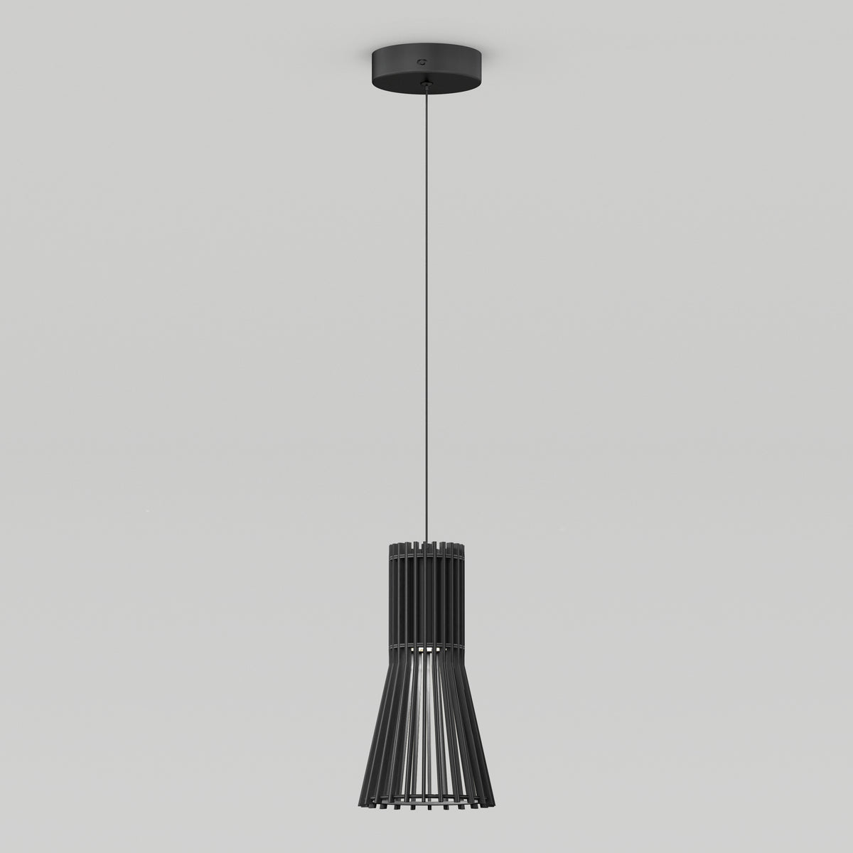 A modern black pendant light with vertical slats hangs from the ceiling by a thin cord against a plain white background.