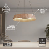 Modern pendant light with a circular painted wood finish hanging over a dining table. Text highlights its adjustable height, energy efficiency (no bulbs required), integrated LED, and 5-year warranty.