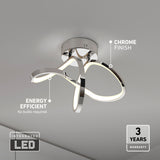 Modern ceiling light fixture with chrome finish and integrated LED strips, featuring a flowing, looped design. Text highlights “energy efficient,” “chrome finish,” and a “3 years warranty.” No bulbs required.