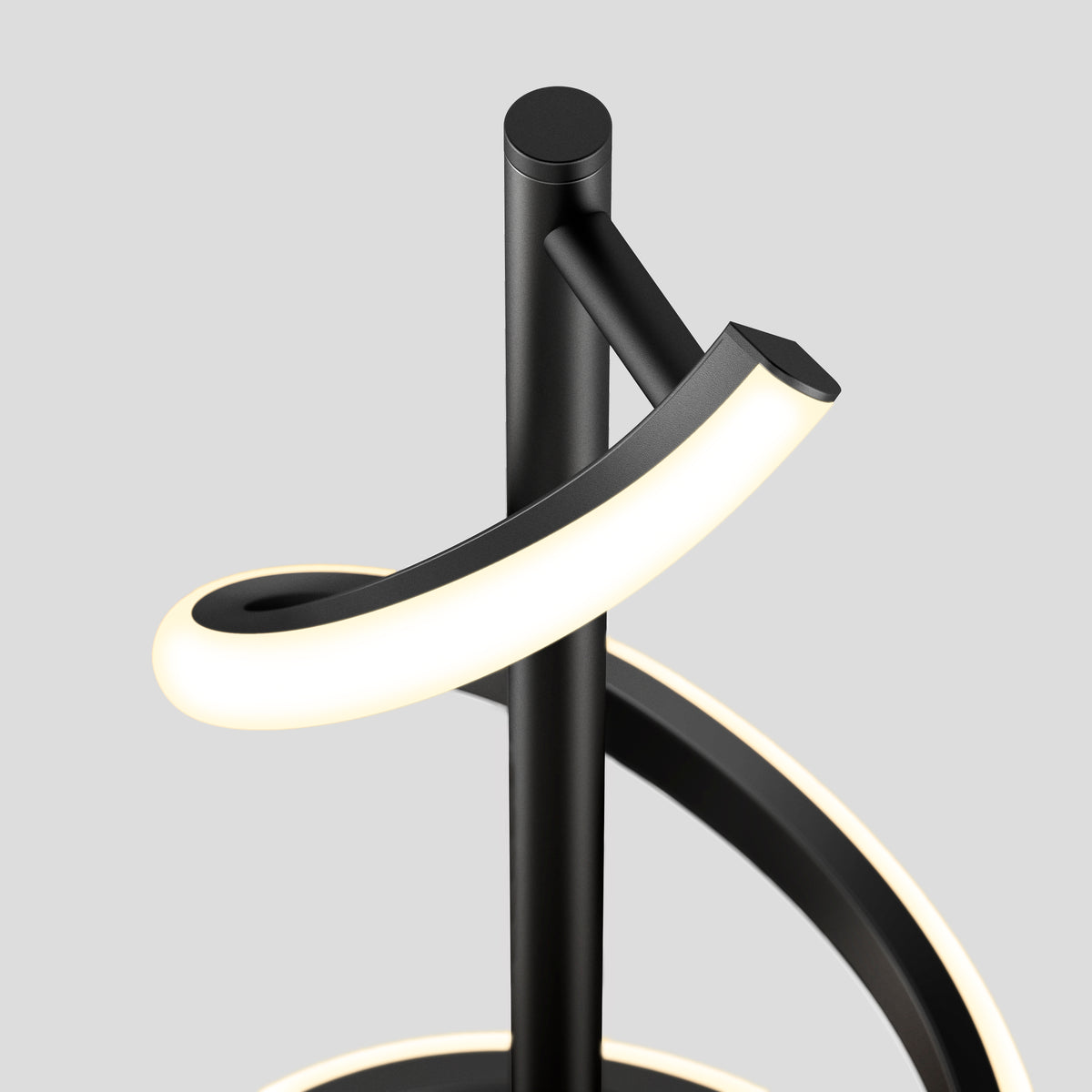 The Artika Coda modern LED floor lamp 5CCT features curved black light strips spiraling around a central pole, shown against a plain light gray background.
