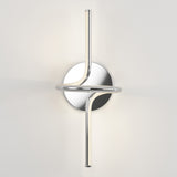 A modern wall sconce with two sleek, curved chrome rods intersecting through a circular base, emitting soft white light against a plain white wall.