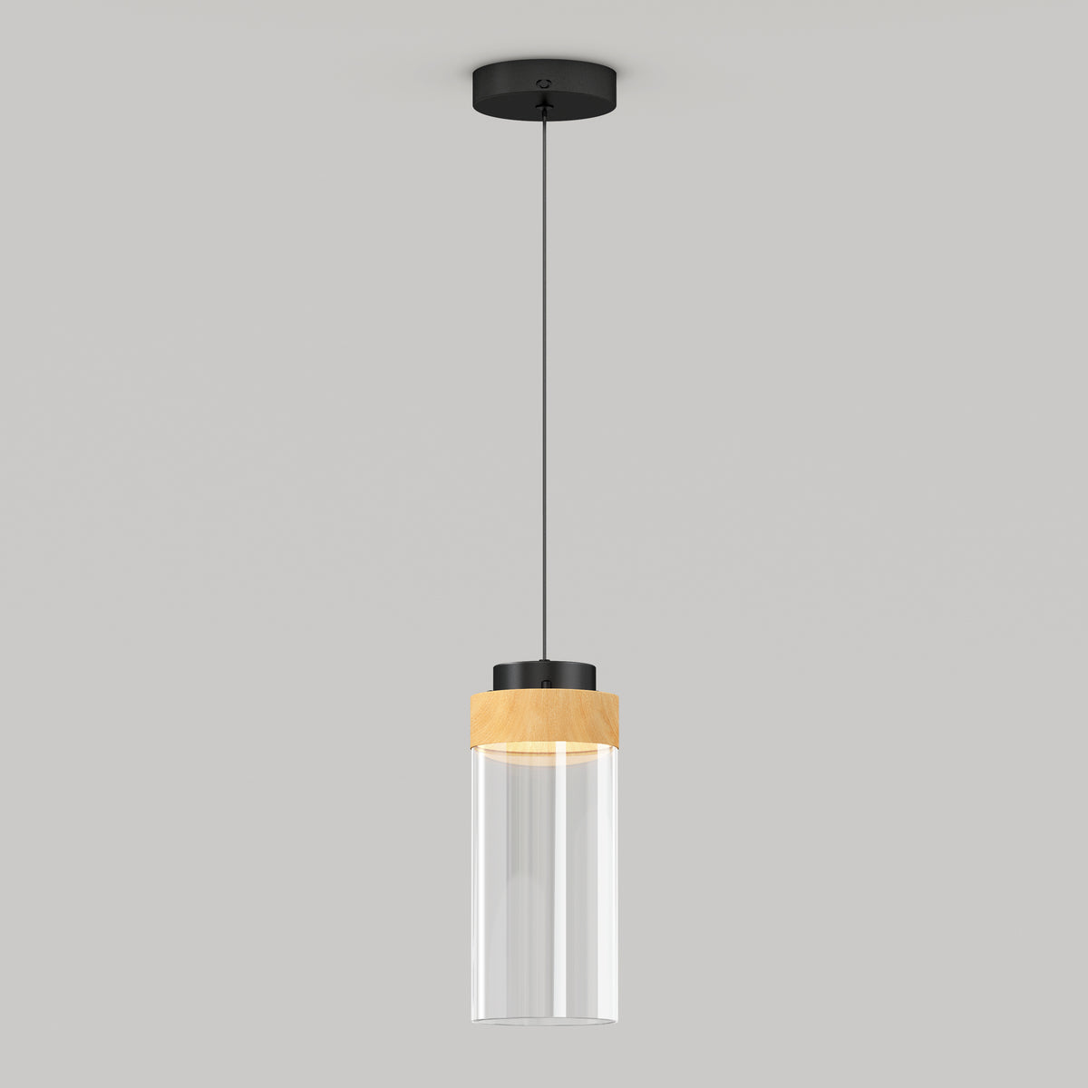A modern pendant light with a black ceiling mount, black cord, and a cylindrical glass shade featuring a wooden accent near the top, hanging against a plain light gray background.