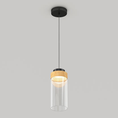 The Artika Hanson 1-light LED pendant features a black ceiling mount, black cord, wooden accent, and cylindrical clear glass shade, shown against a plain light gray background.