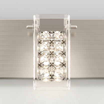 The Artika Crystal Cube LED bathroom vanity light 5 CCT is a modern wall sconce with a rectangular clear glass shade featuring faceted crystal-like accents, mounted on a brushed metal backplate and illuminated from within.