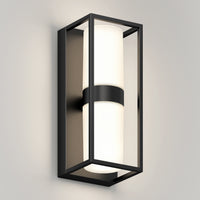 The Artika Sherman modern LED indoor-outdoor wall light 5 CCT features a rectangular black metal frame and cylindrical white frosted glass shade, shown mounted on a light gray wall.