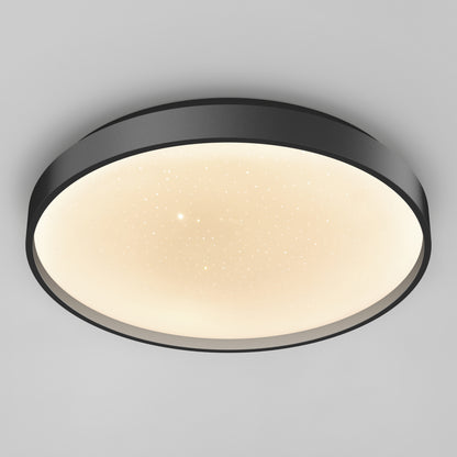 The Artika Celestia 15 in. modern LED flush mount light features a black frame, glowing white diffuser with star-like dots, and comes with a remote—shown mounted on a plain light gray ceiling.
