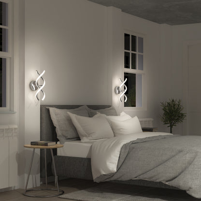 A modern bedroom with a gray upholstered bed, white and gray bedding, two small round bedside tables, unique spiral wall lights, a window, potted plant, and minimalist decor.