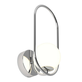 The Artika Bloom LED Sconce 3 CCT features a polished chrome finish with a circular base and an oval frame encircling a frosted globe light for a modern touch.
