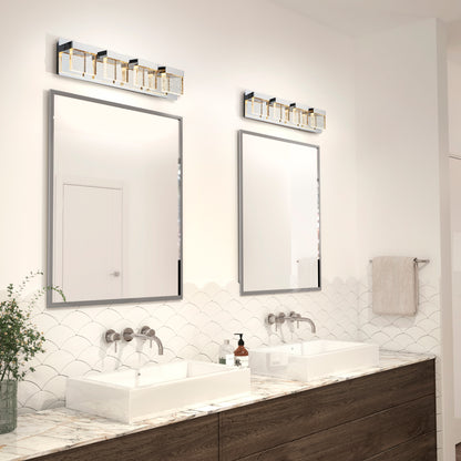 Modern bathroom with two rectangular mirrors above double sinks, wall-mounted faucets, marble countertop, and greenery. Above each mirror is an Artika Bubble Cube 4-light LED vanity light. A towel is hung on the wall.