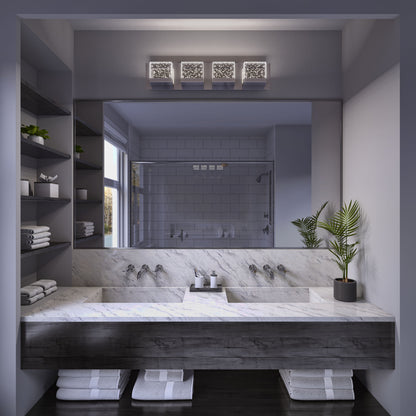 Modern bathroom with a marble double sink vanity, wall-mounted faucets, large mirror, potted plant, shelves with towels, glass shower in the background, and an Artika Bubble Cube 4-light LED vanity light above the mirror.