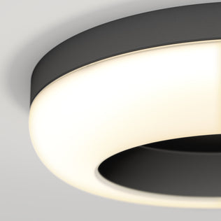 Close-up of Artika Louka 15 in. Modern LED Ceiling Light, black rim and glowing white halo effect.