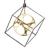A modern pendant light featuring a gold circular structure with LED rings, suspended inside a black open-frame cube.