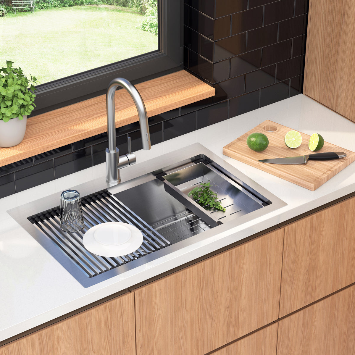 A modern kitchen sink with a faucet, dish rack, glass, white plate, and herbs in the sink. On the counter, there’s a wooden cutting board with a knife, a halved lime, and a whole lime. Greenery is outside the window.