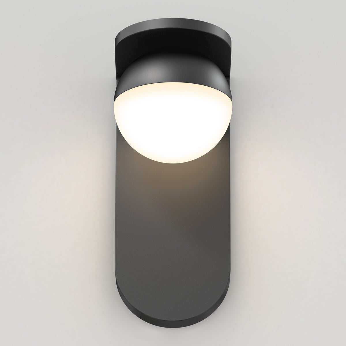 The Artika Bloom indoor-outdoor LED wall light 3 CCT features a modern design with a matte black base and rounded white dome, casting a soft, warm glow against light gray walls.