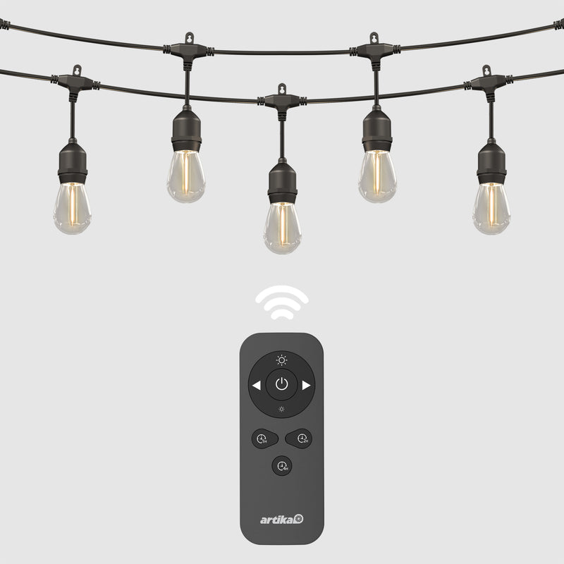 The Eclipse Solar String Light with Remote by Artika features five hanging bulbs and comes with a black remote control for power, brightness, and timer settings. A wireless icon highlights its convenient remote operation.