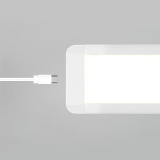A white USB-C cable is positioned near the port of the Artika Maestro under cabinet LED light 3CCT, a rectangular white device, on a light gray background.