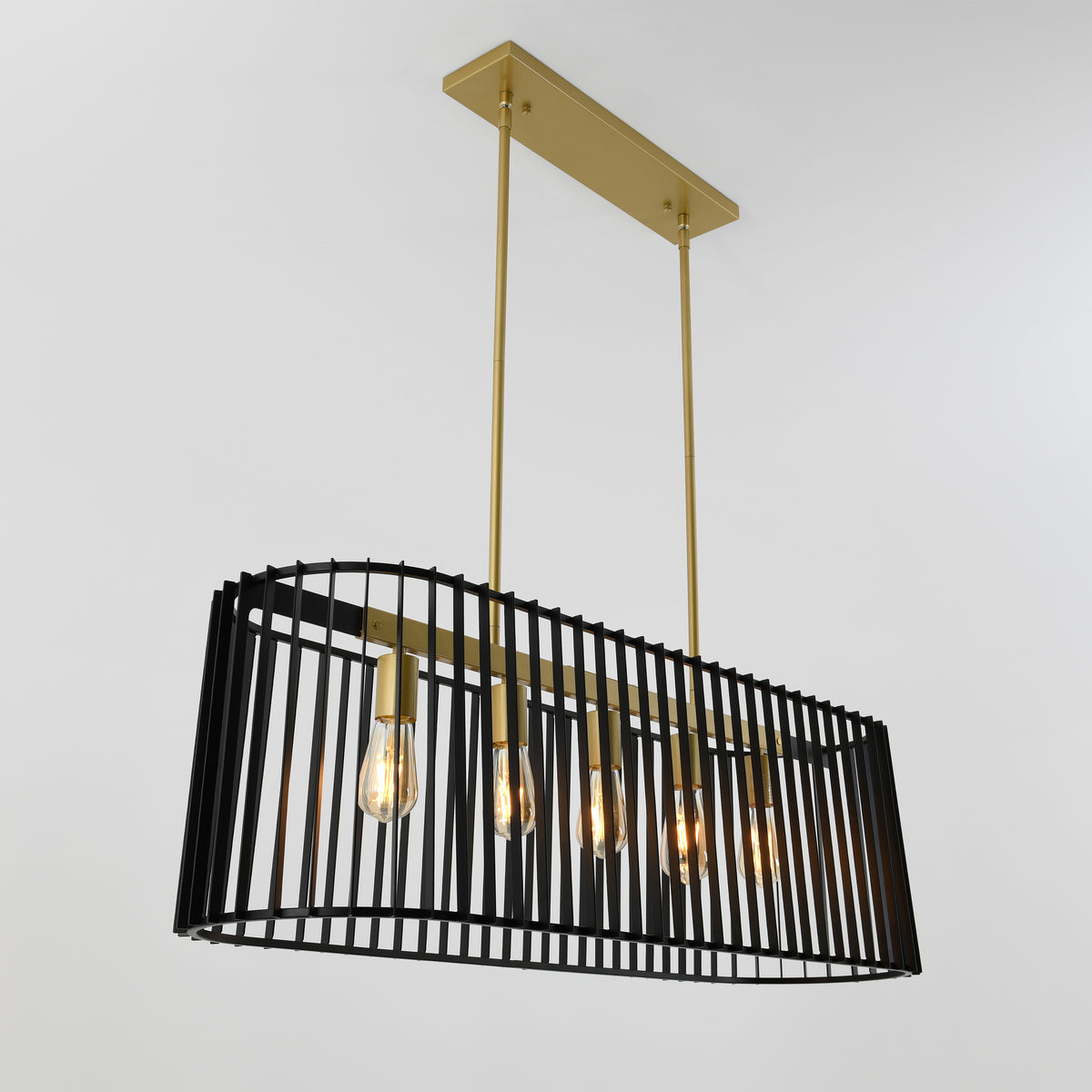 Modern pendant light fixture with a rectangular black metal cage design, five exposed lightbulbs, and gold rods suspending it from a gold ceiling plate, set against a plain white background.