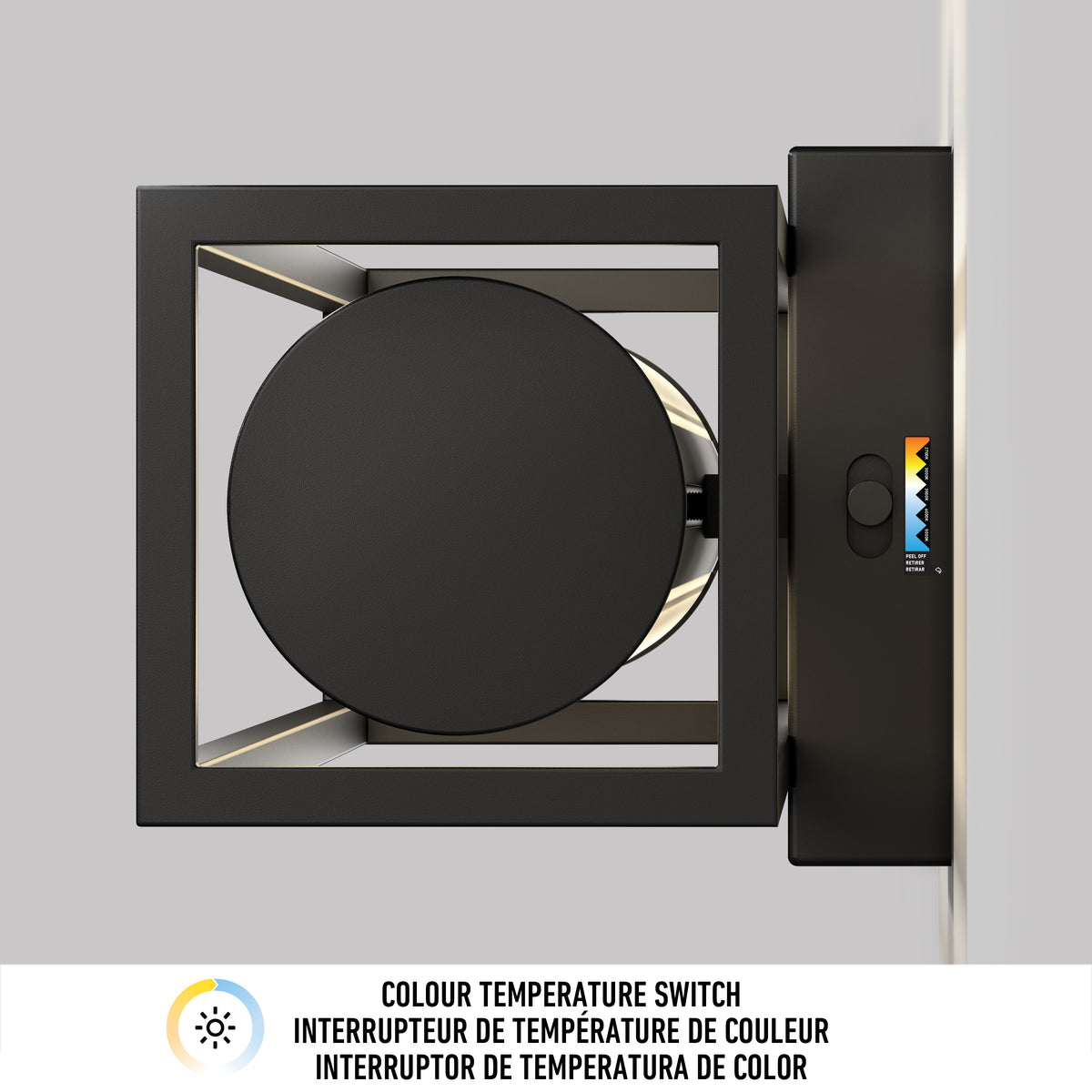 A black, wall-mounted light fixture is shown from above, featuring a circular light source and a color temperature switch with a sliding control and colored indicators. Text below describes it as a colour temperature switch in three languages.