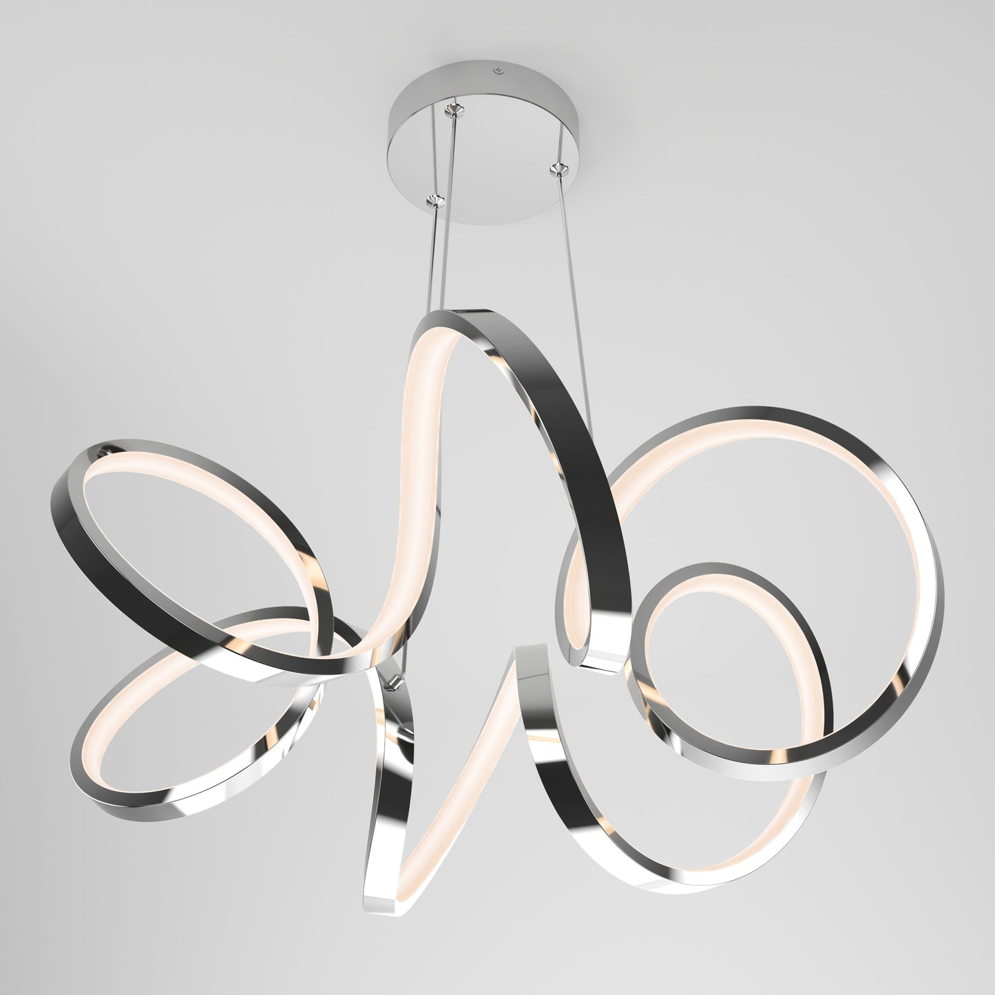 The Artika-CAN-dev Swirl Ribbon LED pendant light features looping chrome bands with integrated LEDs, suspended by two cables from a round base and set against a plain white background.