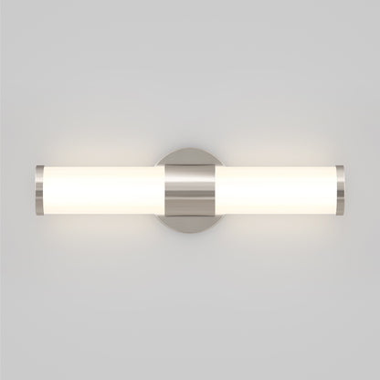 The Artika Adina Modern Bathroom Vanity Light 3 CCT features a cylindrical frosted glass shade with metallic end caps, mounted on a circular base and emits soft white light, perfect for any contemporary space.