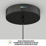 A close-up of a round black ceiling light fixture with a visible color temperature switch, shown against a white ceiling. Text below reads Colour Temperature Switch in English, French, and Spanish.