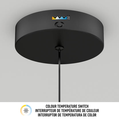 Close-up of the Artika Kiyo modern LED pendant 3 CCT, ceiling-mounted in black with a visible colour temperature switch. Below, “Colour Temperature Switch” appears in English, French, and Spanish with a sun icon to the left.