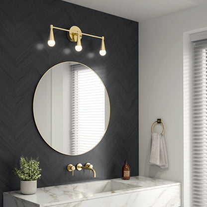 A modern bathroom with a round mirror, gold fixtures, marble sink, patterned dark wall, plant, soap dispenser, gray towel on a ring, window with blinds for natural light, and the Artika Wayden LED mid-century vanity light 3 CCT.
