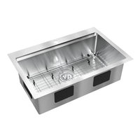 The Artika Newport 33 in. single bowl stainless steel workstation sink features a rectangular basin, center drain, bottom metal rack, pre-drilled faucet hole on the back edge, and visible black soundproofing pads on the sides.