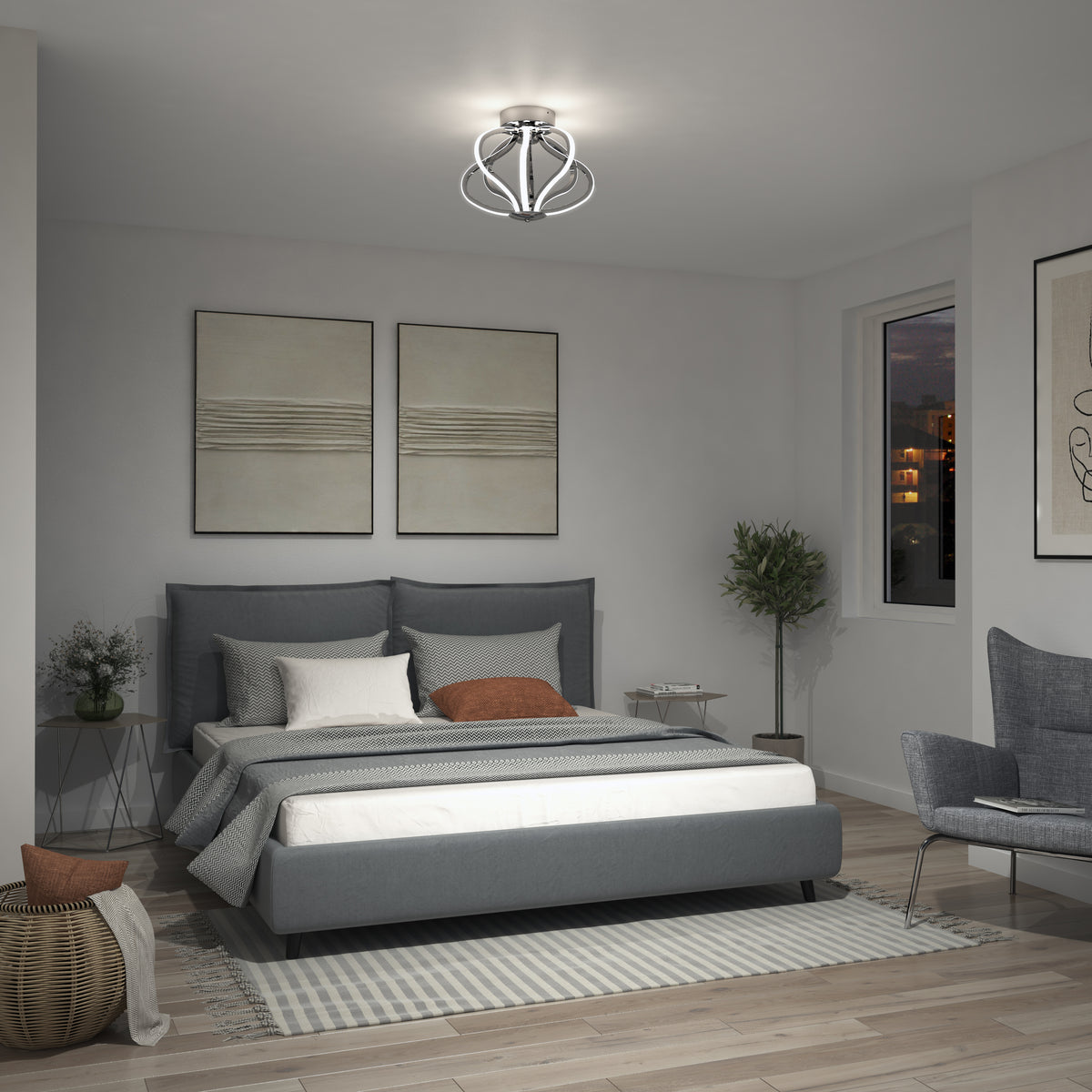 Modern bedroom with a gray upholstered bed, neutral bedding, two abstract wall art pieces, a geometric ceiling light fixture, a plant, and a window showing a nighttime city view. A woven basket and armchair are also visible.