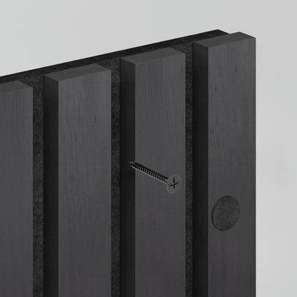 A close-up of the Artika Sonolok 15.5 ft sound-absorbing wall panel kit displays its dark wood finish with vertical grooves, a partially inserted silver screw, and a circular indentation visible on one groove.