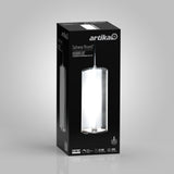 A black retail box features the Artika brand and an image of a cylindrical LED pendant light called Subway Round, with product details and icons displayed on the front. The background is light gray.