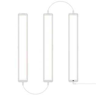 Three Maestro under cabinet LED light 3CCT bars by Artika are connected by cables and arranged vertically side by side against a white background, emitting a bright, even white light.