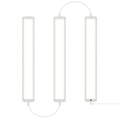 Three Maestro under cabinet LED light 3CCT bars by Artika are connected by cables and arranged vertically side by side against a white background, emitting a bright, even white light.
