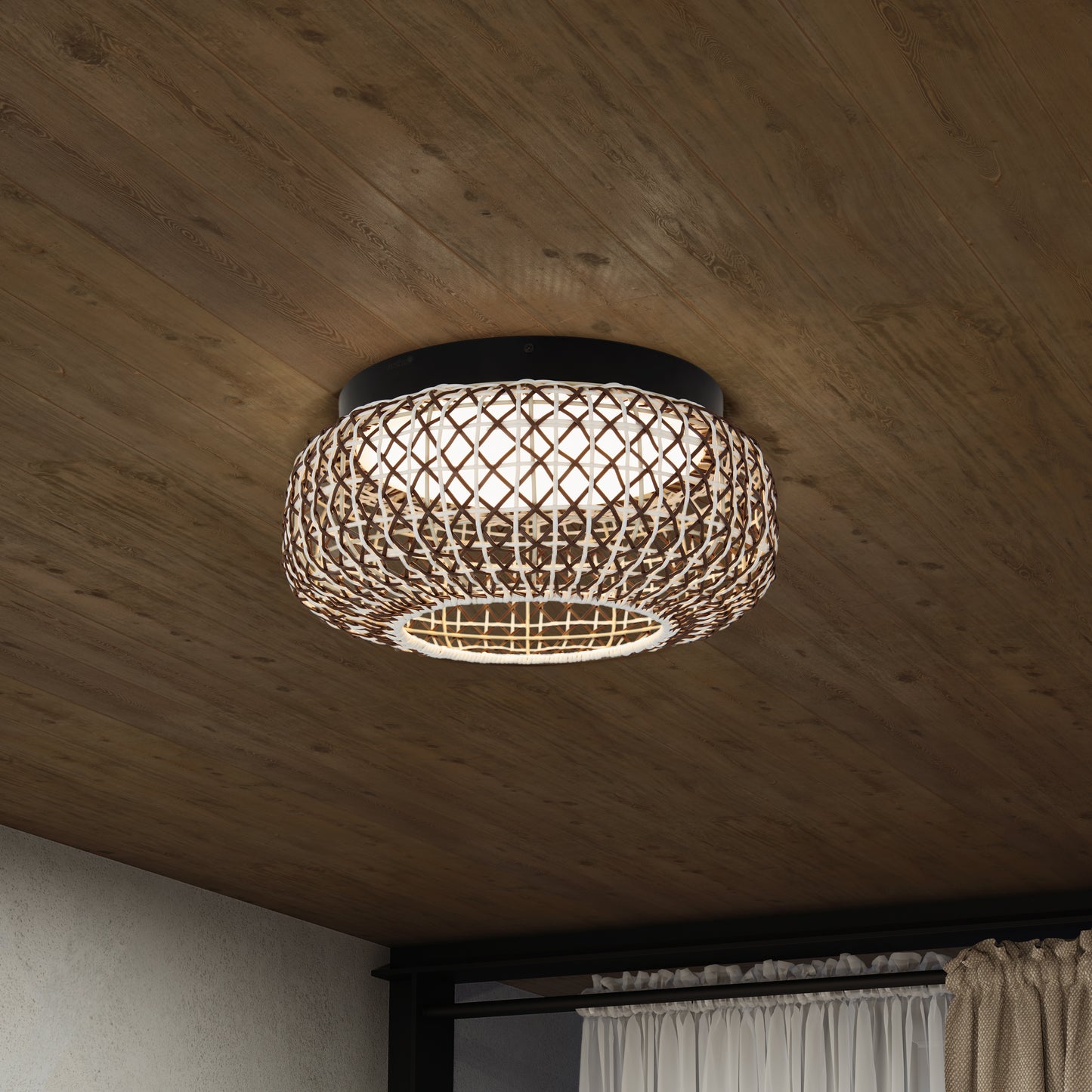 The Artika Benson 15 in. LED flush mount light 5 CCT features a round design and is installed on a wooden ceiling in a modern room, positioned near a window with curtains.