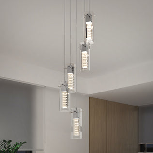 The Artika Hologram 5-light LED pendant features five rectangular glass lights in a staggered arrangement with chrome-accented circular diffusers, adding a modern touch to contemporary rooms with neutral walls and greenery.